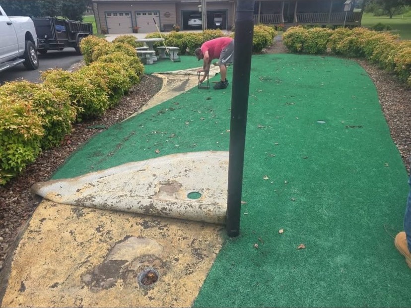 Old putting green being removed during a turf repair by S & J Synthetic Turf