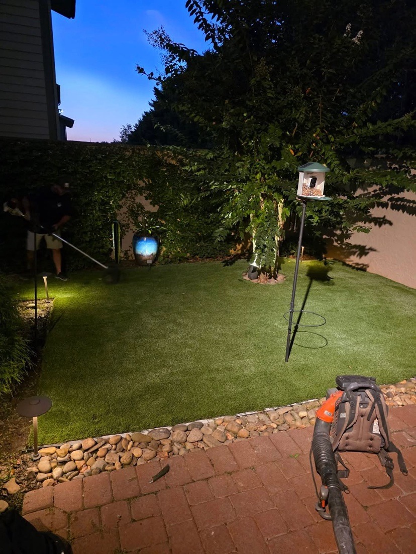 Patio turf at dusk — after | S & J Synthetic Turf
